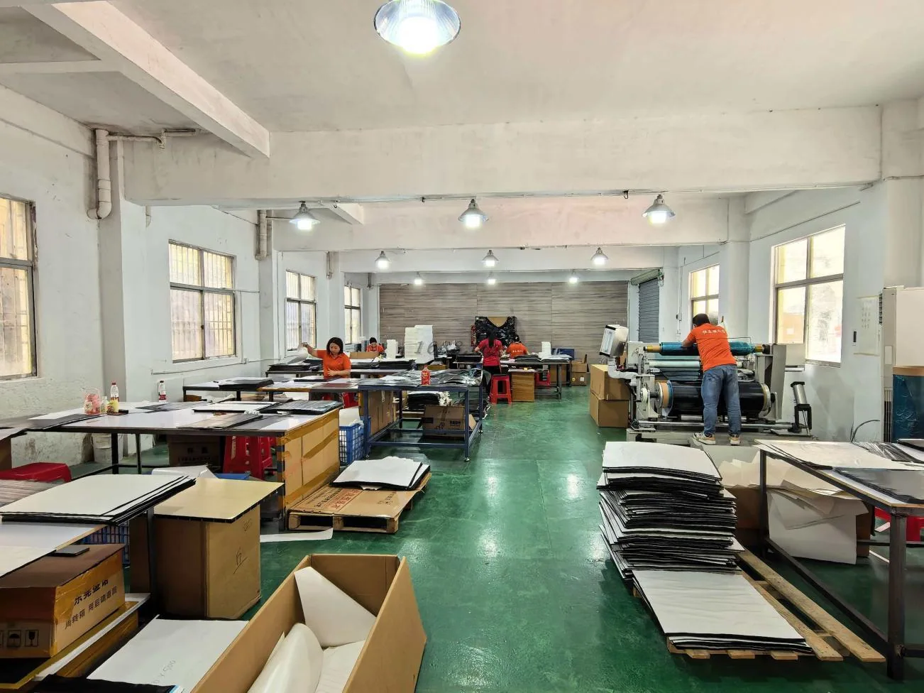 Workshop area with assembly tables and operators