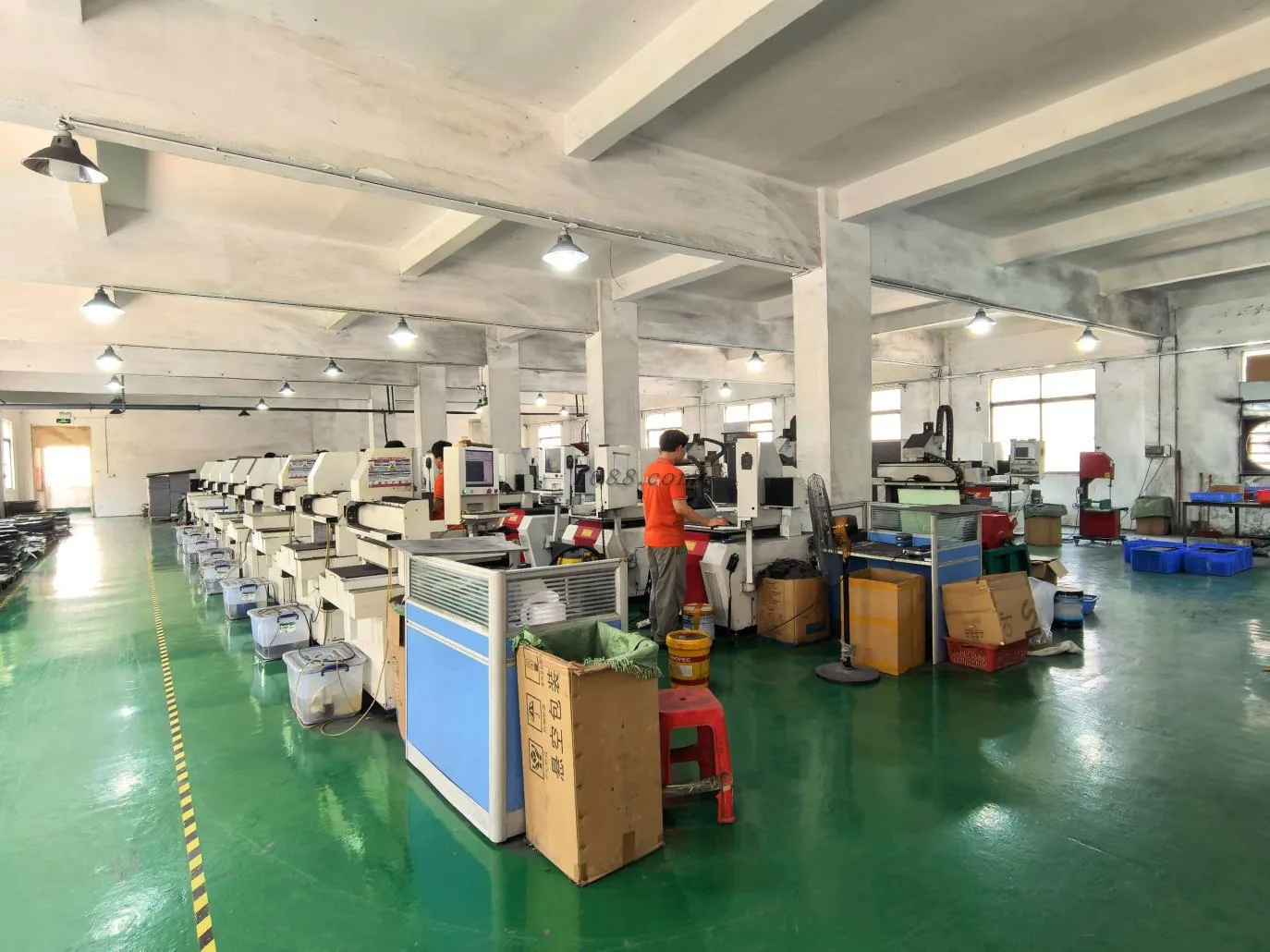 Workshop interior with rows of machinery and production benches