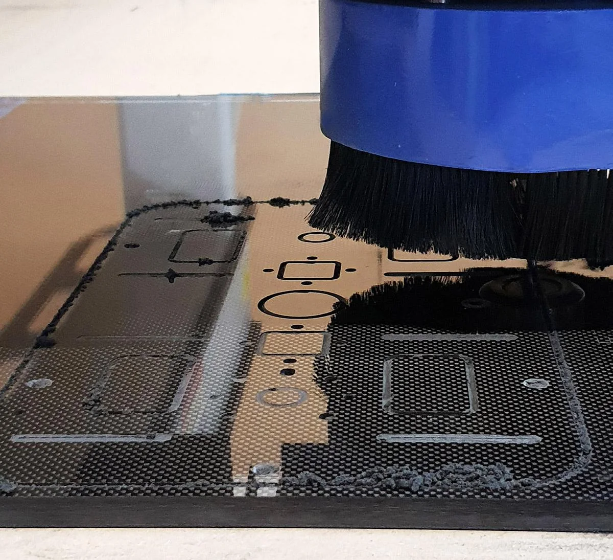 Carbon fiber composite sheet being cut or machined