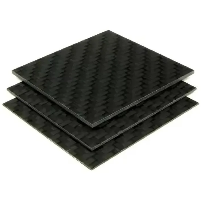 Stacked square dark carbon-fiber panel samples viewed from an angle