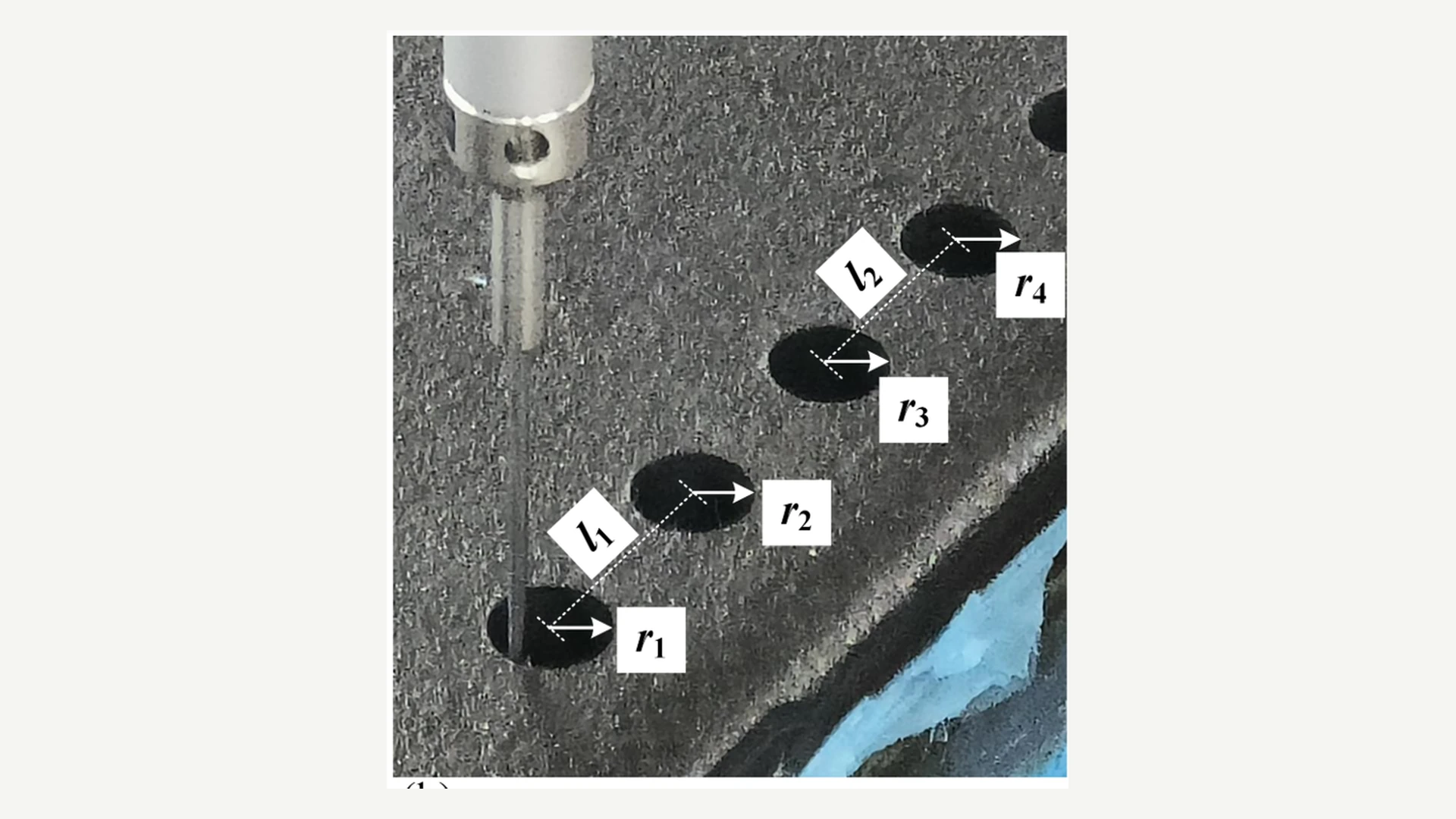 Close-up of a dimensional inspection probe contacting a hole in a carbon-fiber composite part